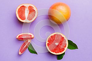 fresh Fruit grapefruit with Juicy grapefruit slices on colored background. Top view. Copy Space. creative summer concept