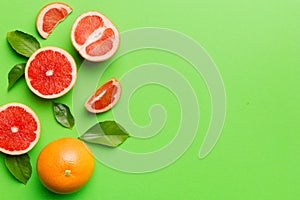 fresh Fruit grapefruit with Juicy grapefruit slices on colored background. Top view. Copy Space. creative summer concept