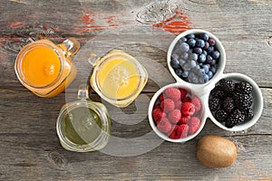 Fresh fruit juice with a dish of mixed berries