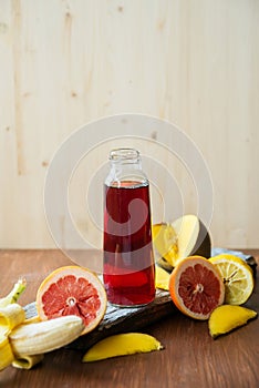 fresh fruit juices on wooden table, on window background