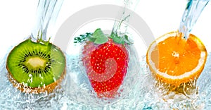 Fresh fruit jumping into water with a splash