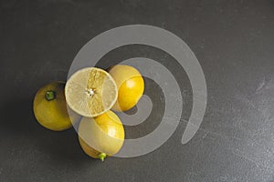 Fresh fruit lemons with lemon slice on black table