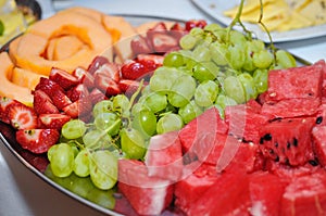 Fresh fruit melon strawberry pineapple and grapes