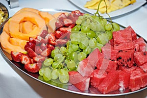 Fresh fruit melon strawberry pineapple and grapes