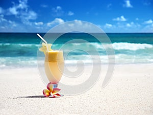Fresh fruit mix of juices on a beach