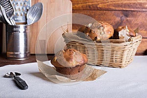 Fresh fruit muffin or cake with raisins on the wooden brown table background. Side view. selective focus.