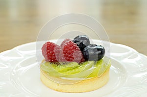 Fresh fruit pie tart with kiwi, blueberry, and raspberry