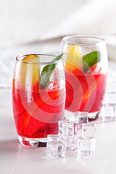 Fresh fruit punch with orange slice and ice cube for refreshment