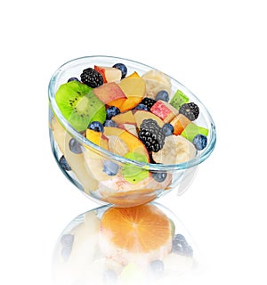 Fresh fruit salad in a glass bowl with reflection