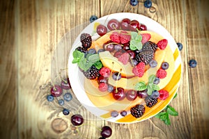 Fresh fruit salad made with organic fruits in plate