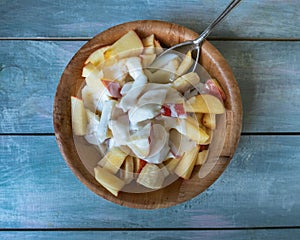 Fresh fruit salad with natural yogurt in deep bamboo cup