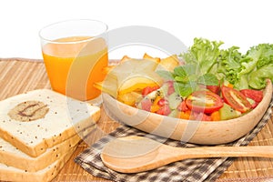 Fresh fruit salad with orange juice and slice bread