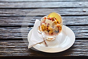 Fresh fruit salad in a plate on a wooden background