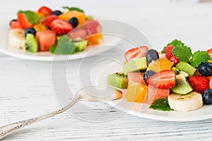 Fresh fruit salad on wooden table. Close up