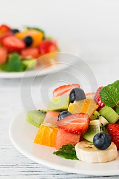 Fresh fruit salad on wooden table. Close up