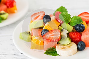 Fresh fruit salad on wooden table. Close up