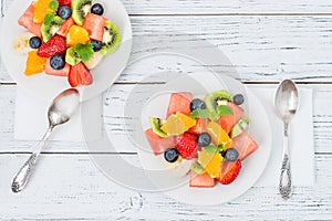 Fresh fruit salad on wooden table. Top view