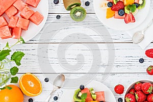 Fresh fruit salad on wooden table. Top view