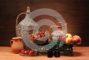 Fresh fruit, scales, and dishes on the table photo