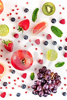 Fresh fruit variety. Pomegranate, grapes, blueberries etc, forming a pattern