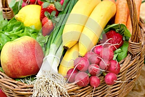 Fresh fruit and vegetable in wicker basket closeup