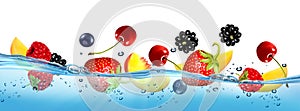 Fresh fruits and berries splashing in water waves with air bubbles and sunbeams.