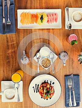 Fresh fruits for breakfast on wooden table. Healthy food concept. Flat lay, top view.