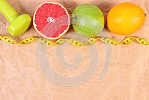 Fresh fruits, centimeter and dumbbells for fitness, concept of healthy lifestyles