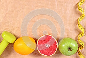 Fresh fruits, centimeter and dumbbells for fitness, healthy lifestyles