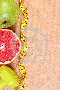 Fresh fruits, centimeter and dumbbells for fitness, healthy lifestyles