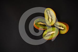 Fresh fruits on a dark background. Orange and kiwi in a cut isolated on a black background. Copy space. high resolution