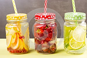 Fresh fruits flavored water in jars