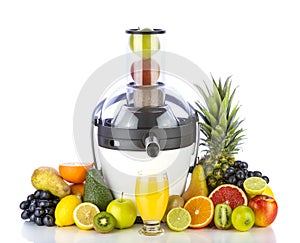 Fresh fruits and glass with juice near juicer photo