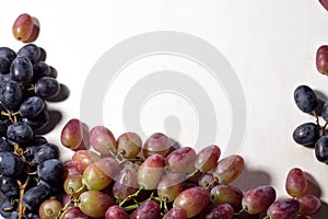 Fresh fruits grapes, pear and apple on wooden boards frame background.