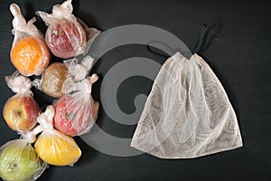 Fresh fruits in individual disposable plastic package and trendy reusable eco grocery mesh, conscious consumerism