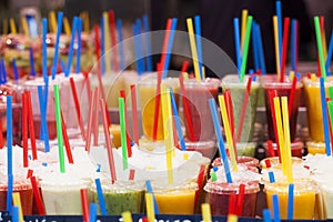 Fresh fruits juices and colorful drinking straw