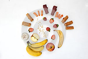 Fresh fruits, pastilles and oatmeal on a white table