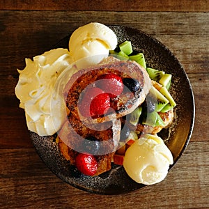 Fresh fruits salad with ice cream on plate and berries with grilled chicken