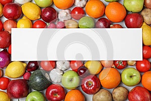 Fresh fruits and vegetables with blank card on light background, flat lay