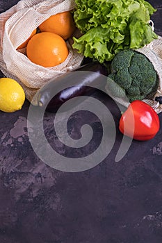 Fresh fruits and vegetables in eco cotton bags on table