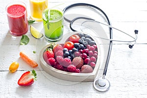 Fresh fruits vegetables and heart shape with stethoscope health diet concept