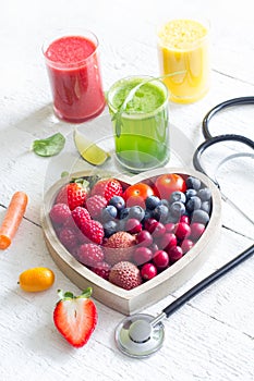 Fresh fruits vegetables and heart shape with stethoscope health diet concept