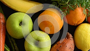 Fresh fruits and vegetables on kitchen table from above.