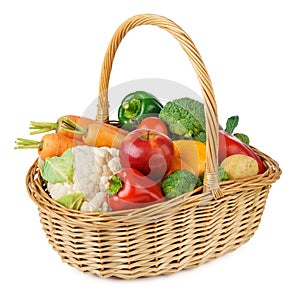 Fresh fruits and vegetables in a wicker basket. Isolated