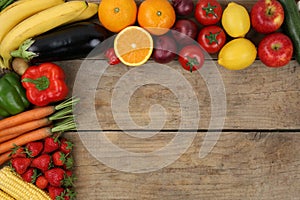 Fresh fruits and vegetables on wooden board with copyspace