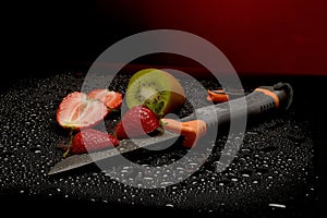 Fresh fruits with water drops on them and knife