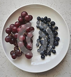 Fresh fruits in a white plate.