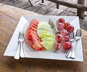 Fresh fruits on a white plate