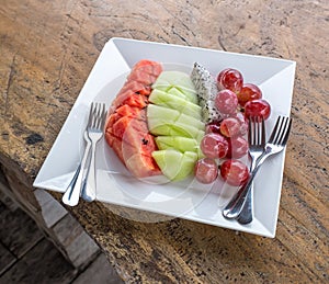 Fresh fruits on a white plate