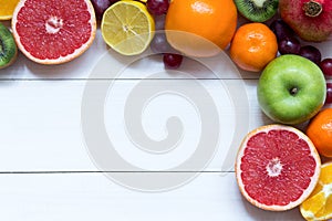 Fresh fruits on wooden boards frame background